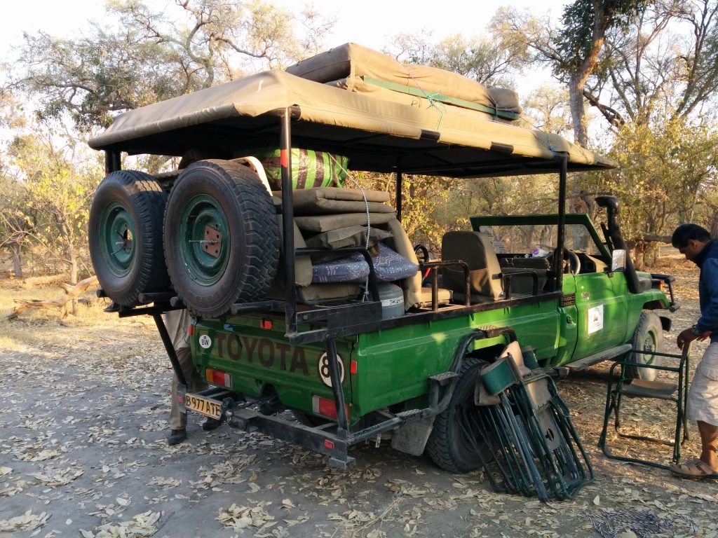 Botswana safari: green safari truck loaded with camping gear