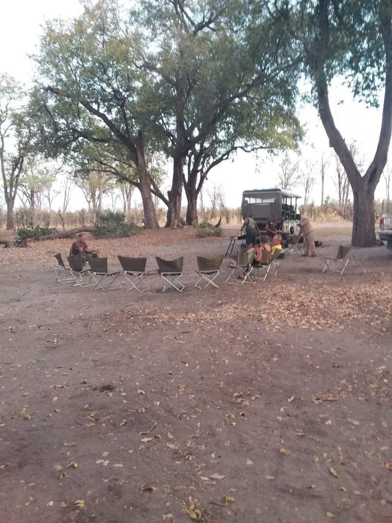 Botswana safari: guests and safari truck at bush camp