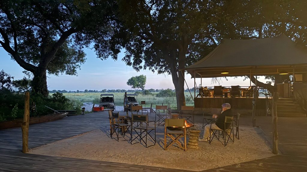 Botswana safari: safari camp firepit and lounge tent at dusk