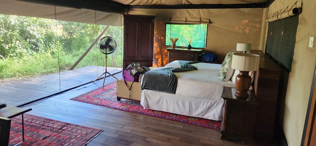 Botswana safari: safari tent interior with large bed and fan