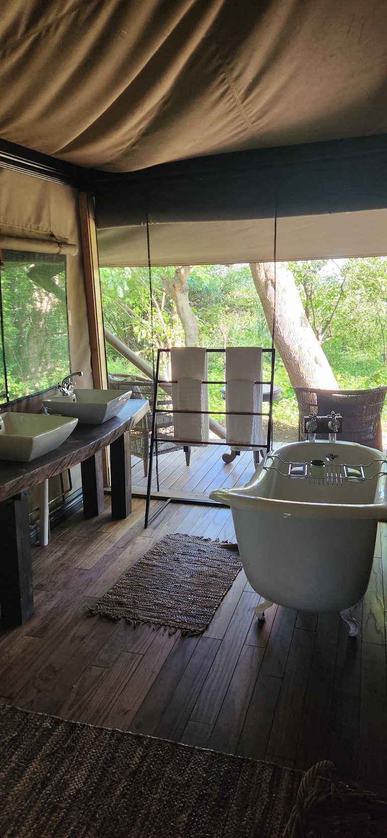 Botswana safari: tented bathroom with clawfoot bath and twin basins