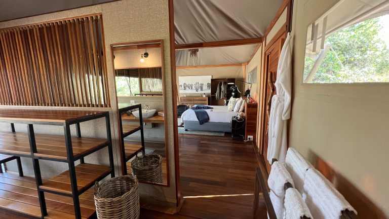 Botswana safari: tented room interior with bed and bathrobe