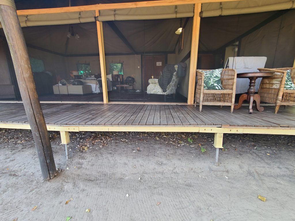 Botswana safari: tented suite veranda with wicker chairs
