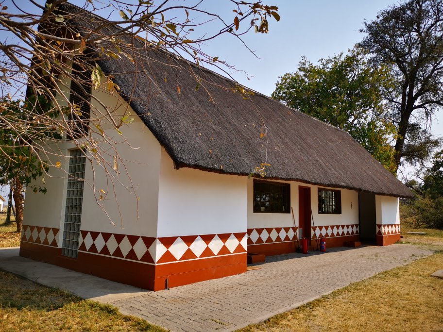 Botswana safari: thatched lodge building with red diamond pattern