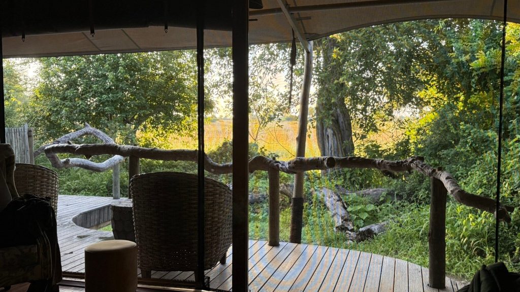 Botswana safari: view from tent onto deck with wicker chairs